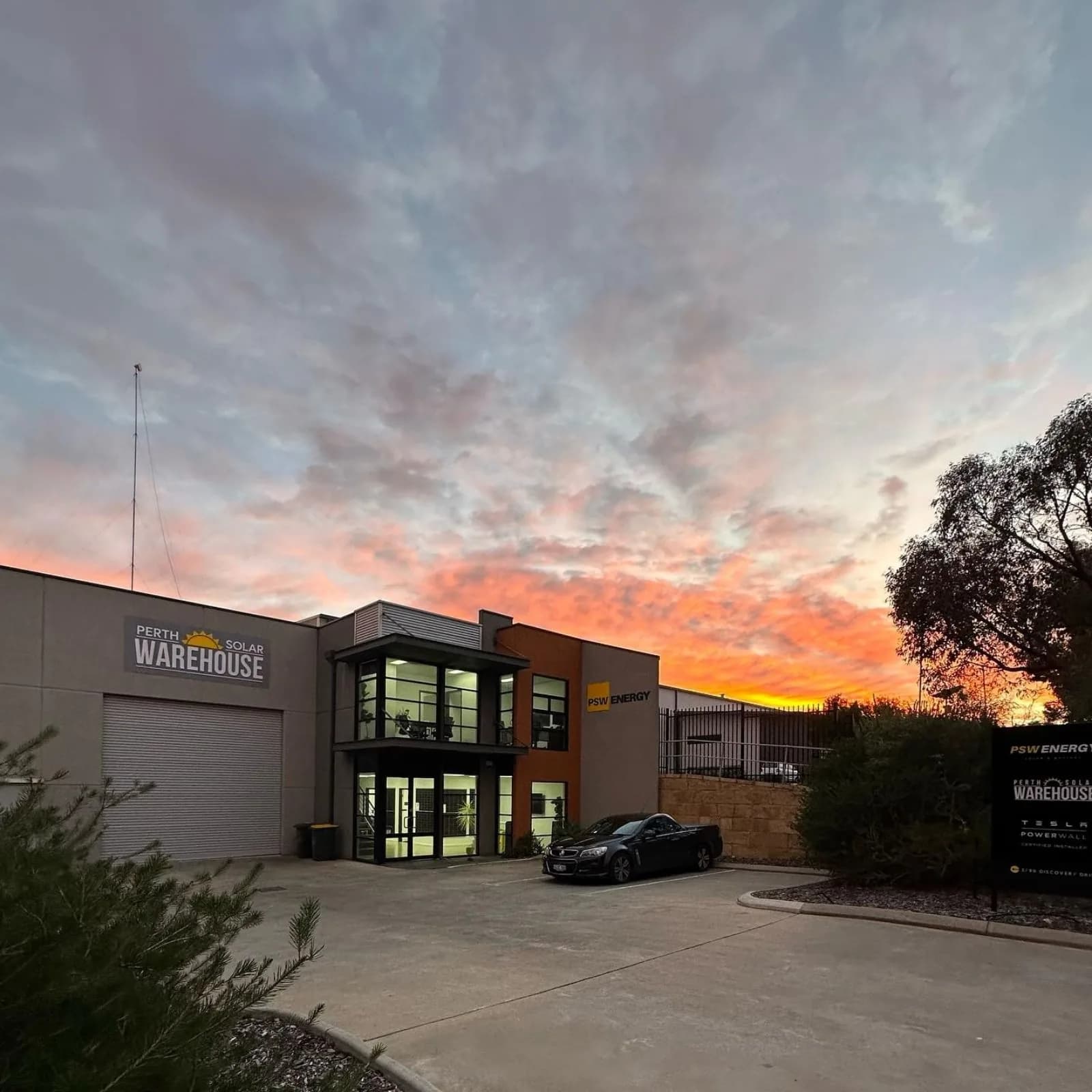 PSW Energy's Bibra Lake head office and showroom, lit from inside at sunset